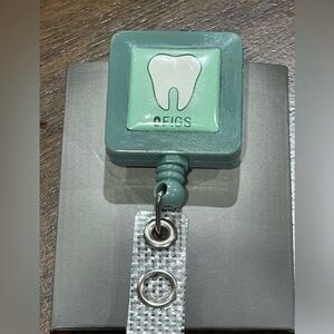 Figs Green Badge Reel with Tooth Emblem